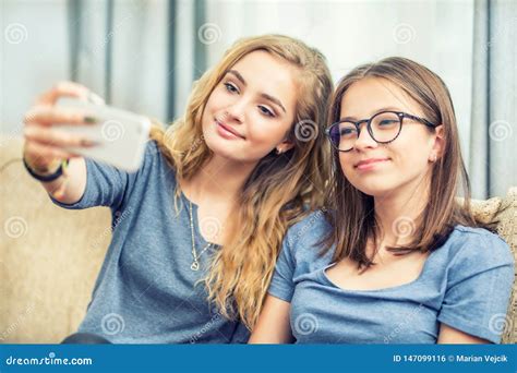 Girls Smile And Take A Selfie Together Grimaces Wink And Sign Four Girls Friends Smile And