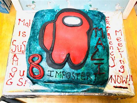 A Birthday Cake With An Image Of A Red And Black Object On Its Side