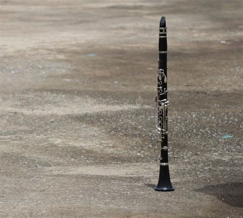Black Wooden Clarinet Instrument Laid On Outdoor Cement Floor Jazz