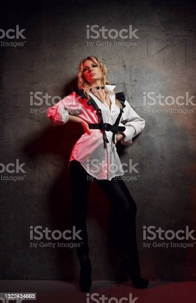 Insolent Blonde Woman Mistress In Leather Pants White Shirt With