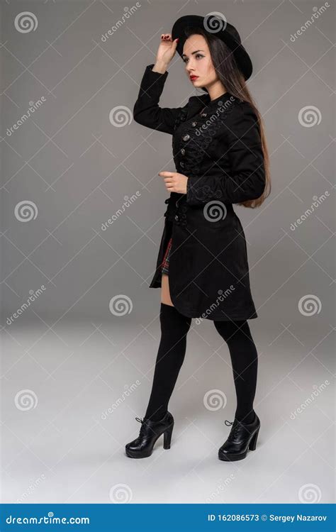 Full Length Portrait Of A Professional Model Posing At Studio Stock