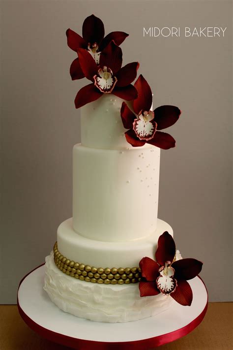 White Fondant Cake With Handmade Burgundy Sugar Orchids Gold Painted