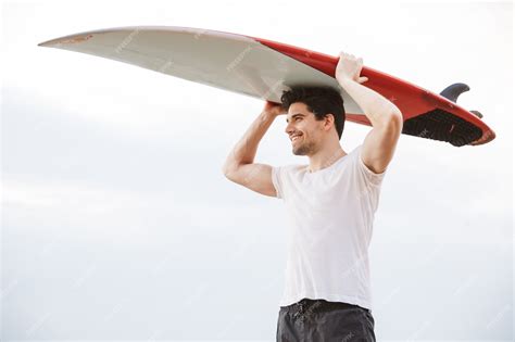 Premium Photo Photo Of A Positive Happy Handsome Man Surfer With