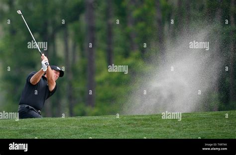 Phil Mickelson blasts out of a bunker on the 4th hole during the final