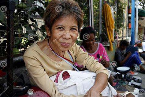 An Adult Filipino Woman Sitting On A Sidewalk Pose For The Camera Editorial Image Image Of