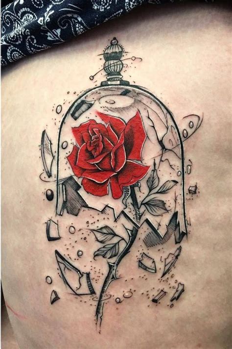 A Womans Back With A Rose In A Glass Case Tattoo On Her Thigh