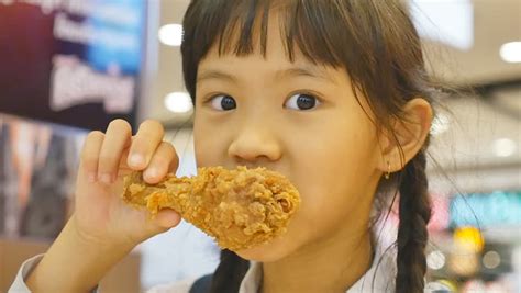 Asian Child Enjoys Eating Fried Chicken Stock Footage Video 9030682