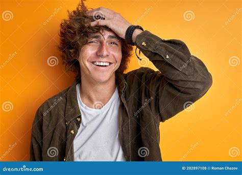 Smiling Man With Curly Hair Posing At Camera Isolated Stock Photo