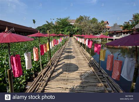 Bamboo Footbridge With Many Umbrellas And Lanterns Over Big Pond At
