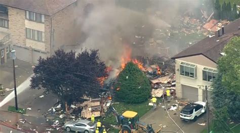 Fire Crews Work To Battle A Massive House Fire After An
