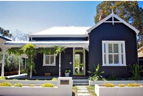 A darker colour palette helps a home recede into its natural. Australian weather board | Exterior paint colors for house, Weatherboard house, House color schemes