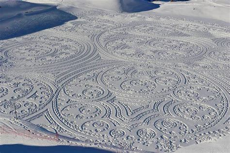 Expansive Geometric Drawings Trampled In Snow And Sand By