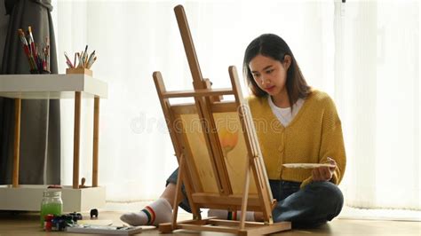 A Female Artist In Her Studio Working With Watercolour Painting Stock