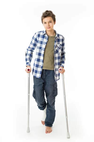 Teenage Boy With Crutches And A Bandage On His Right Leg Stock Photo By