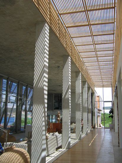 The Inside Of A Building With Lots Of Windows And Wooden Slats On The
