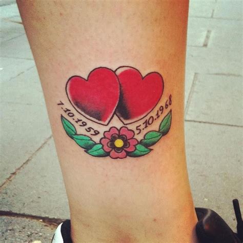 Two Hearts With Leaves And Flowers On The Side Of A Womans Leg That Says