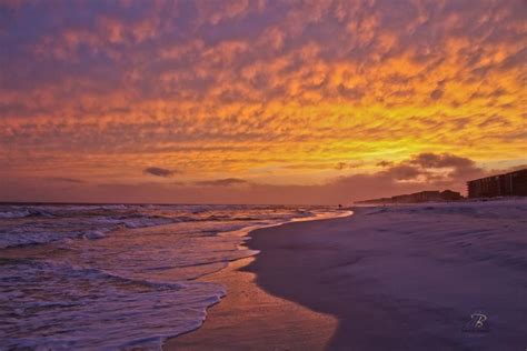 The Sun Is Setting At The Beach With Waves Coming In To Shore And