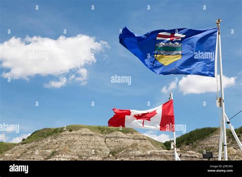 The Alberta And Canada Flags Flutter In Wind At The Badlands Of Alberta Close To Drumheller In