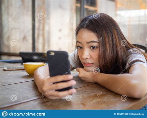 The Girl Sat Staring At The Phone In Hand A Sad Expression Awaits The Babefriend Calling Stock
