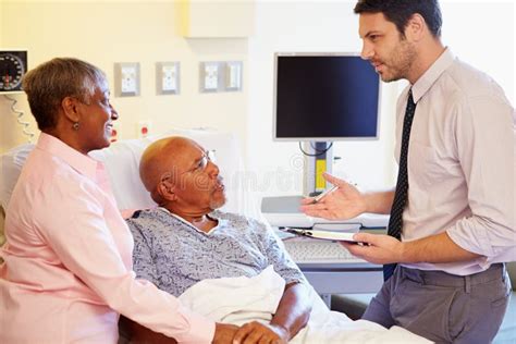 Doctor Talking To Senior Couple On Ward Stock Image Image Of