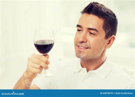 Happy Man Drinking Red Wine From Glass At Home Stock Photo Image Of