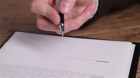 Male Hand Signing A Document Hand With Pen Signs Paper Another