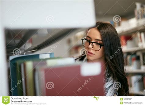 Student Woman Searching Books In Boekhandel Of Bibliotheek Stock