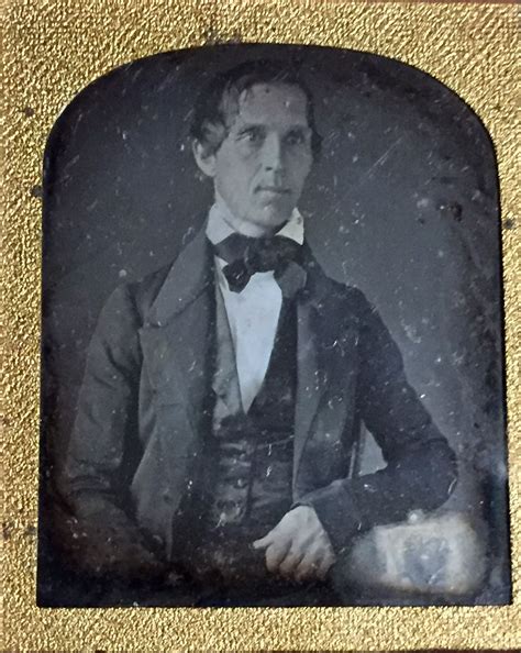 An Old Photo Of A Man In A Suit And Bow Tie