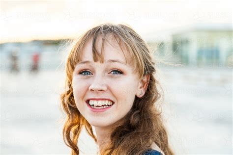 image of teen girl looking over her shoulder smiling austockphoto