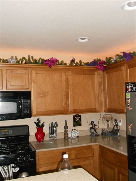 Since my particular space between ones upper kitchen. If you have extra space above your cabinets. Add some garland and Christmas lights to light up ...