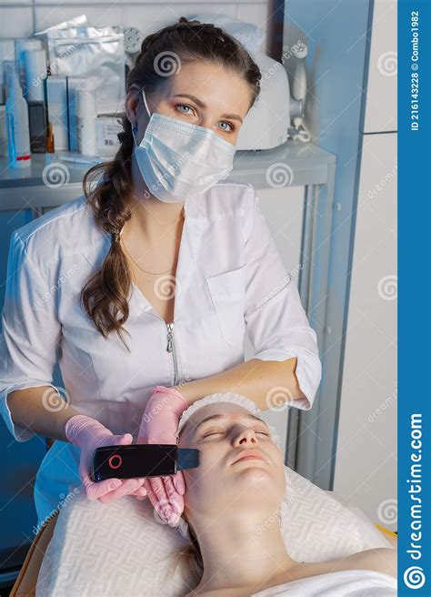 A Professional Cosmetologist Performs An Ultrasonic Face Cleaning