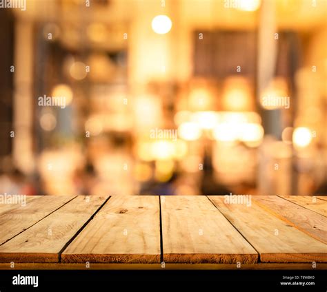 Wood Texture Table Top Counter Bar With Blur Light Gold Bokeh In Cafe