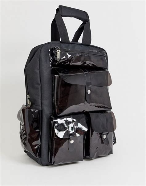 Clear transparent pet carrier provides great visibility for your pet. SVNX black backpack with clear plastic pockets | ASOS