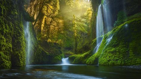 Green And Black Covered Mountains And Waterfalls Near