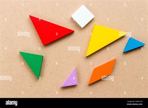Color Tangram Puzzle Wait To Complete Shape On Wood Background Stock