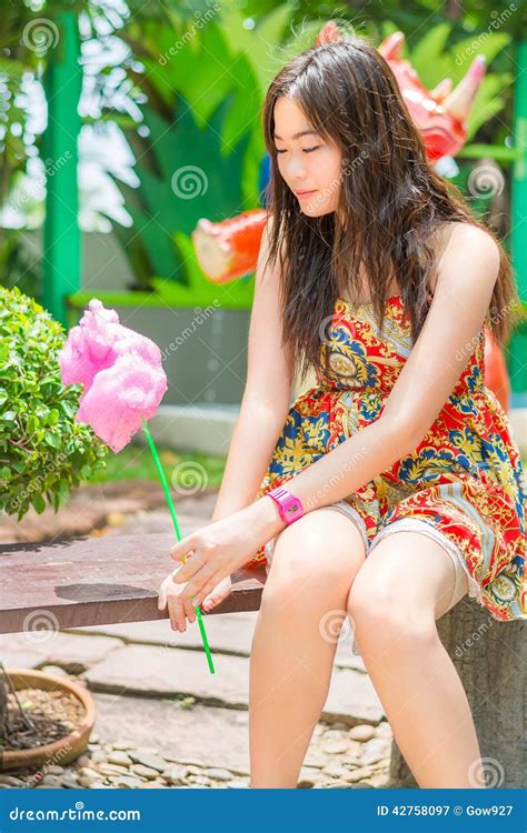 Cute Thai Girl Is Sitting While Holding Pink Candyfloss Stock Image Image Of Delicious