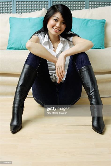Young Woman Sitting On Floor Legs Apart Hands On Knees Photo Getty Images