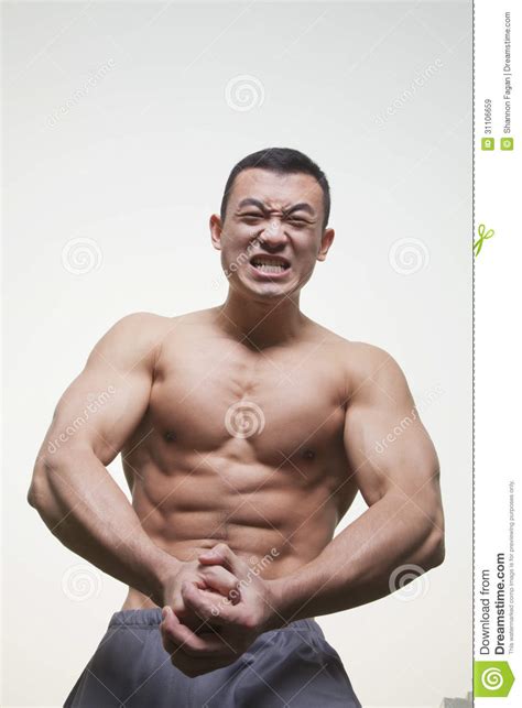Young Muscular Shirtless Man Growling And Flexing His