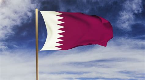 The qatar flag is a white band on the left, separated from a maroon area on the left by nine white triangles on a line. National Flag of Qatar | Qatar Flag Meaning, History and ...