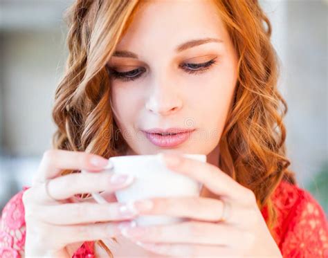 A Young Beautiful Woman Is Drinking Coffee In A Cafe Stock Image