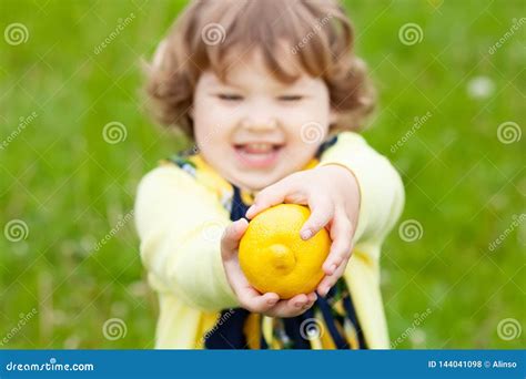 Funny Little Girl With Lemon Fruit Outdoors Stock Photo Image Of