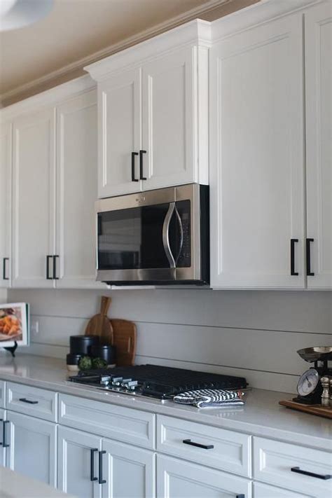 With a stained cabinet finish, it's nice to create some contrast with the hardware by using a white glass knob. White shaker kitchen cabinets accented with oil rubbed ...