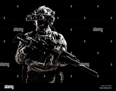 Special Forces Soldier Standing In Darkness Equipped With Night Vision