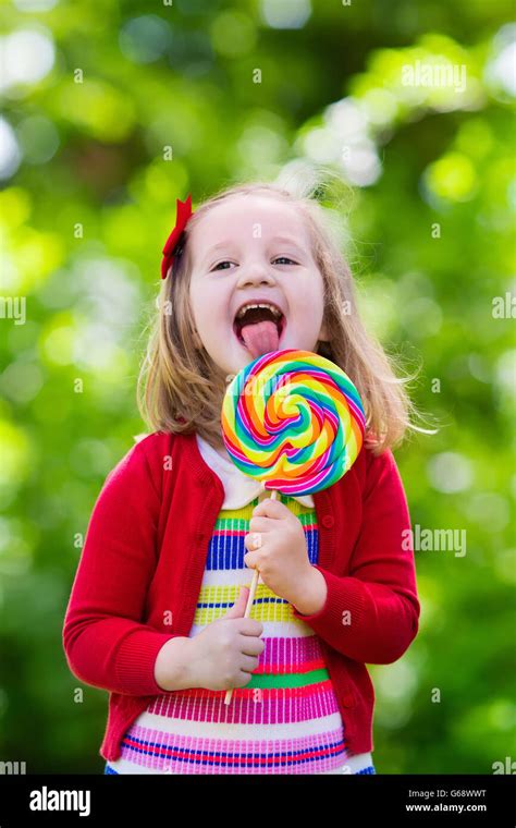 Cute Little Girl With Big Colorful Lollipop Child Eating Sweet Candy