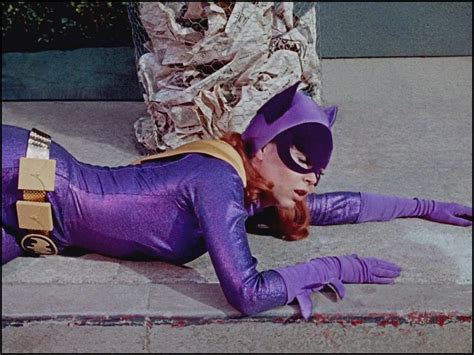 a woman dressed in purple laying on the ground