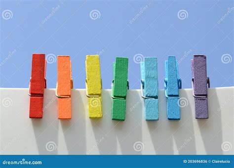 Seven Wooden Multi Colored Clothespins Painted In The Colors Of The