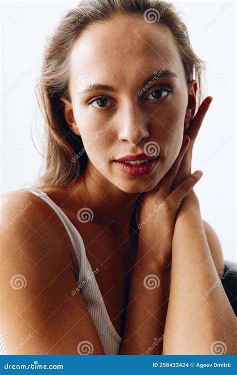 Portrait Of A Woman With A Beautiful Tanned Body Posing On The Couch In