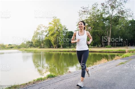 Healthy Beautiful Young Asian Runner Woman In Sports Clothing Running