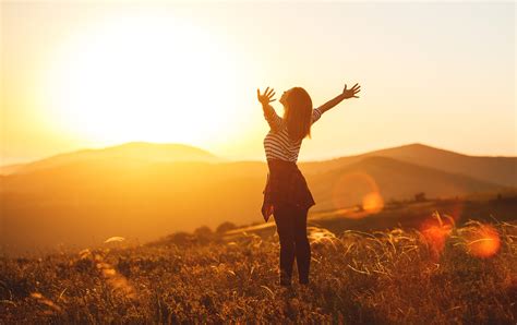 Happy Woman Jumping And Enjoying Life In Field At Sunset In Moun ...