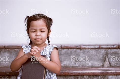 Cute Asian Little Girl Closed Her Eyes And Folded Her Hand